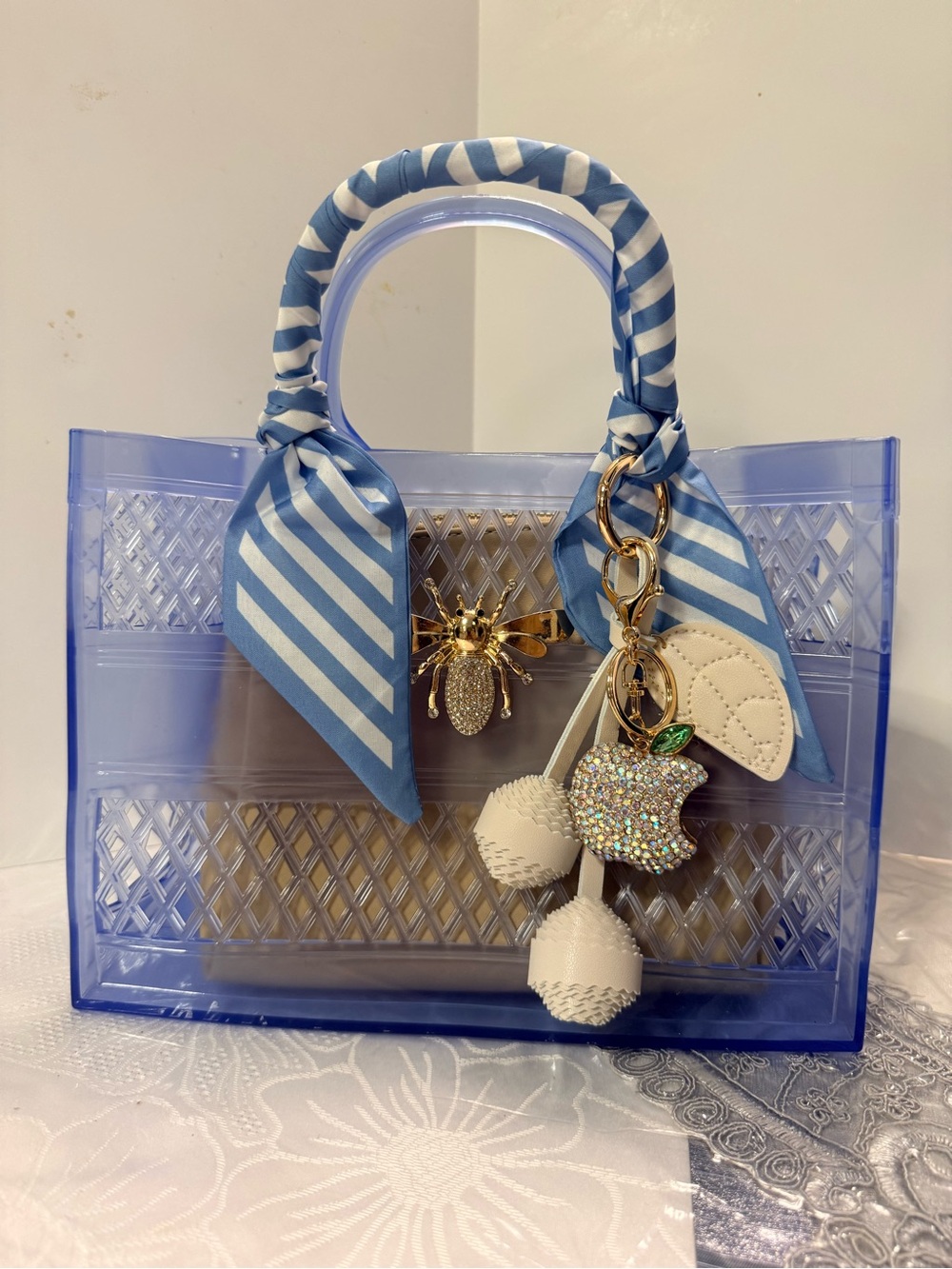 Blue Transparent Tote with Striped Handle and Charm Accent , cosmetic case